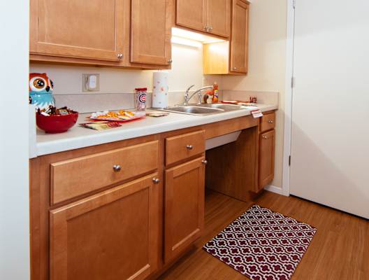 A kitchen with wooden cabinets and a white fridge.
