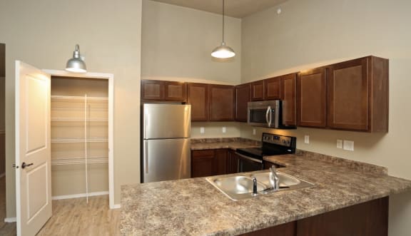 a kitchen with granite countertops and stainless steel appliances
