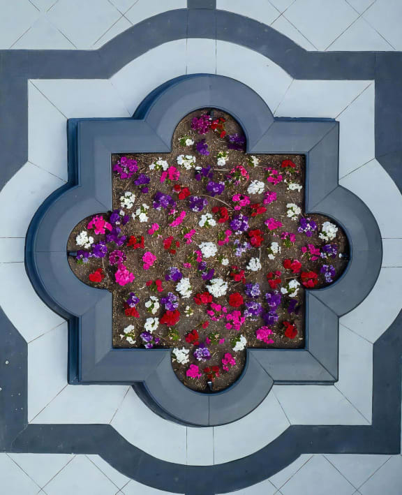 a flower pot with flowers in the shape of a cross