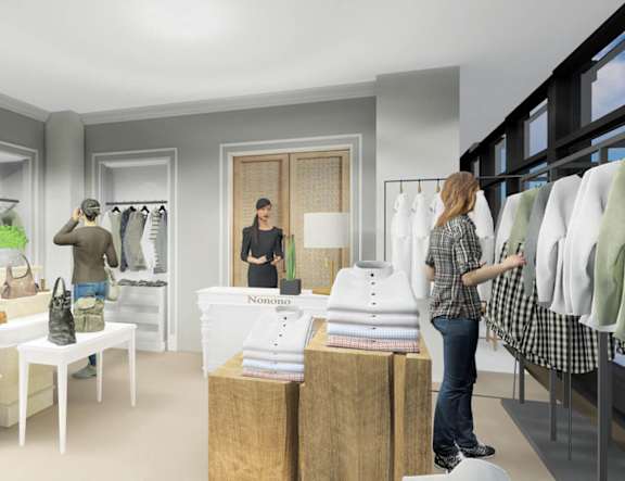 a woman standing in a store looking at clothes on a rack at The Pearl, Fort Wayne