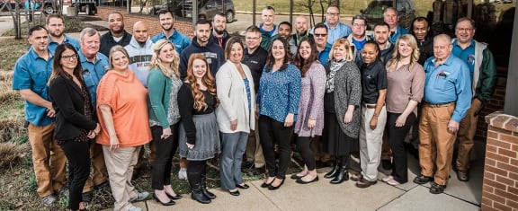 a group of people posing for a group photo