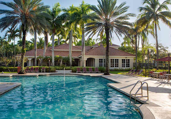 Pool with lounge chairs at Banyan Pointe, Coconut Creek, Florida