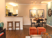 Thumbnail 24 of 55 - a living and dining room area with a table and chairs