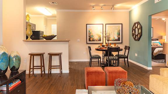 a living and dining room area with a table and chairs