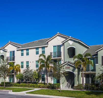 Mirabella Apartments community exterior with palm trees at Mirabella Apartments, Princeton, FL