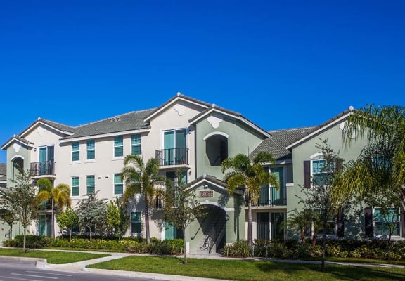 Mirabella Apartments community exterior with palm trees