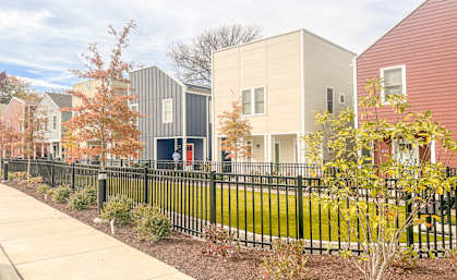 a row of houses with a sidewalk in front of them