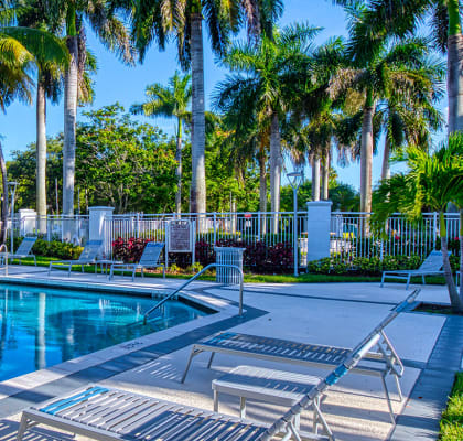 Pool with lounge chairs Aqua 2800 Apartments in Oakland Park Florida