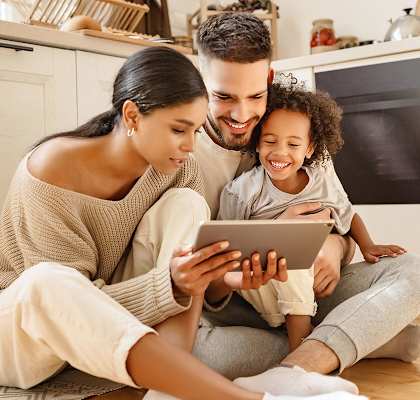 Family in the kitchen looking at tablet at Doral Terrace, Doral, 33178