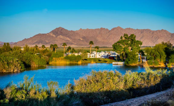 a body of water with mountains in the background
