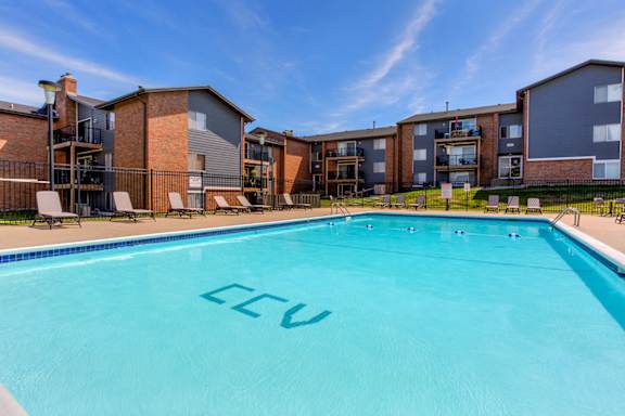 country club village apartments pool with apartment buildings in the background