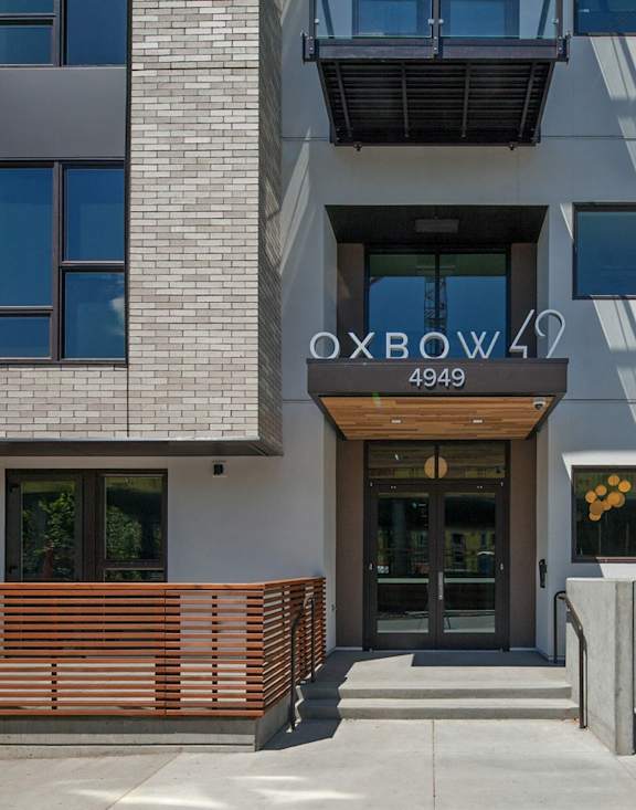 The entrance to a building with the sign "OXBOW 49" above it.