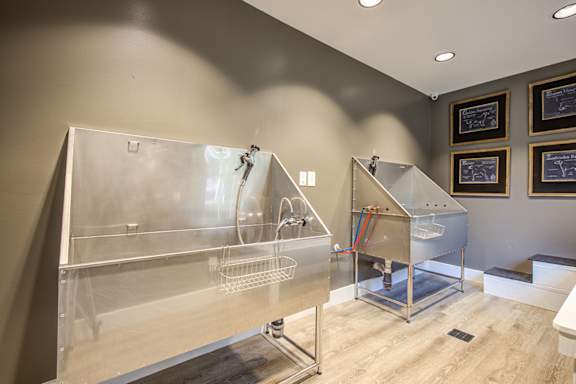 a bathroom with two stainless steel tubs and a sink