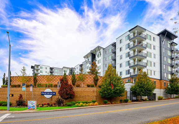 a picture of an apartment building with a blue sky in the background