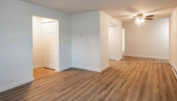 A room with wooden floors and white walls.