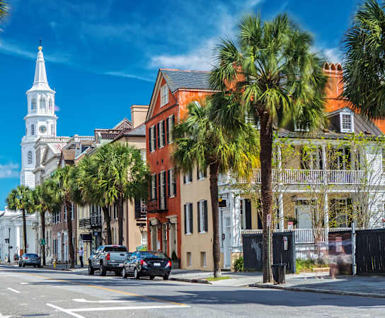 a street in charleston with palm trees and a church in the background at Wharf 7 Apartments, South Carolina, 29492