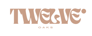 a logo that reads weaved oaks on a black and pink background