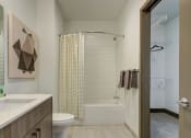 Thumbnail 26 of 33 - Kansas City MO Apartments-The Grand Apartments Bathroom With White Countertop And Square Tile And Neighboring Closet  at The Grand, Kansas City, MO