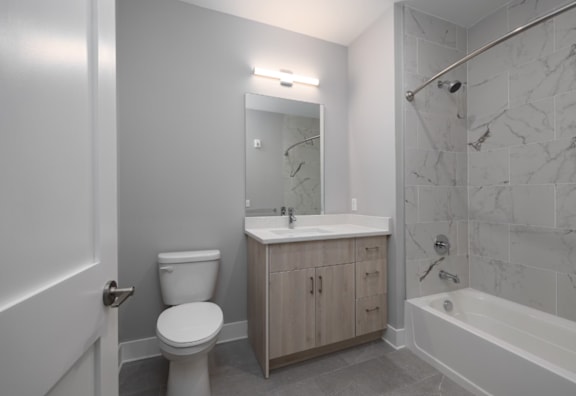 A white toilet sits next to a sink in a bathroom.