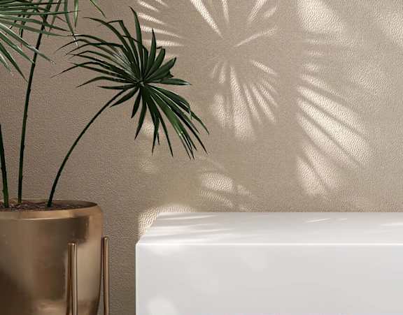 A white sink with a gold faucet and a gold vase with a green plant at Stillwater Lakes Apartments, Florida 34744