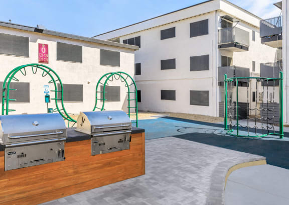 a patio with a grill and a swimming pool