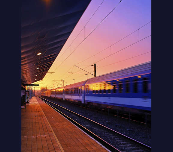 a train pulling into a train station at sunset at The Bell in Trenton, NJ, 08608