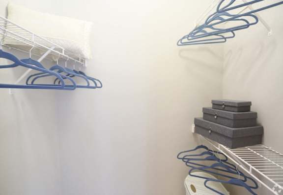 a closet with shoe racks and a white wall