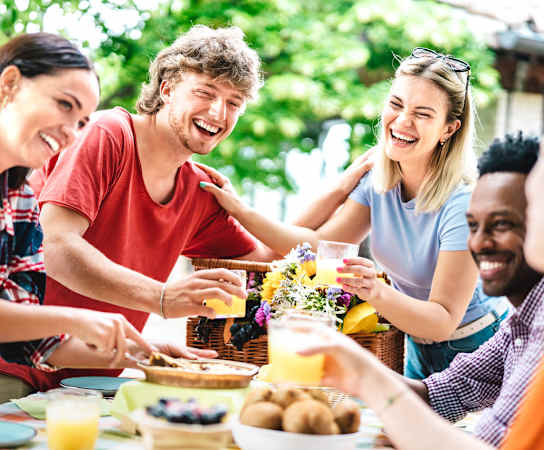 a group of people sitting around a table with food and drinks at The Park at Monterey Oaks, Texas