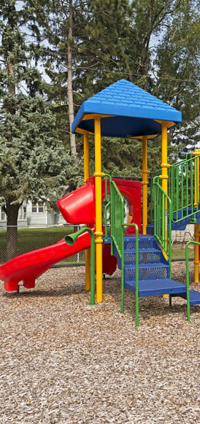 A playground with a red slide and a blue roof. at Minnehaha Manor, Oakdale, 55128