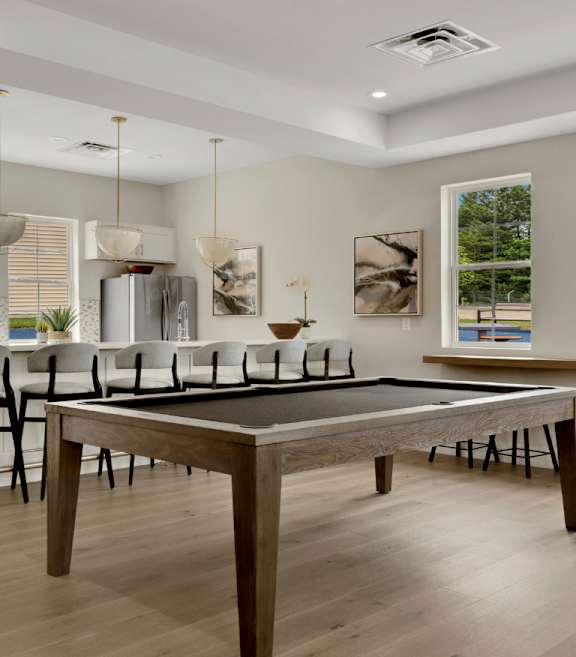 Community clubroom with billiards and kitchen