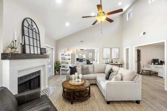 A modern living room with a fireplace and a large mirror on the wall.