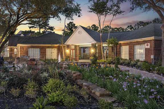 A house with a garden in front of it.