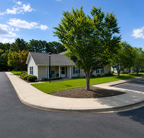 A house with a tree in front of it.