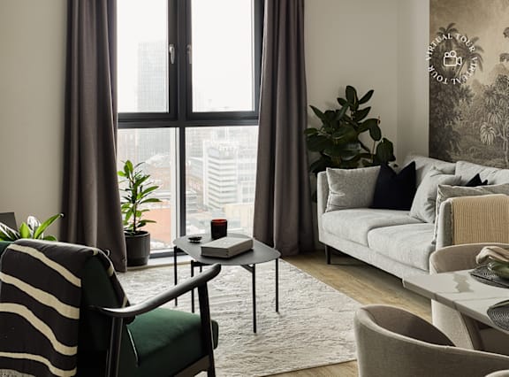 a living room and dining room with a table and chairs