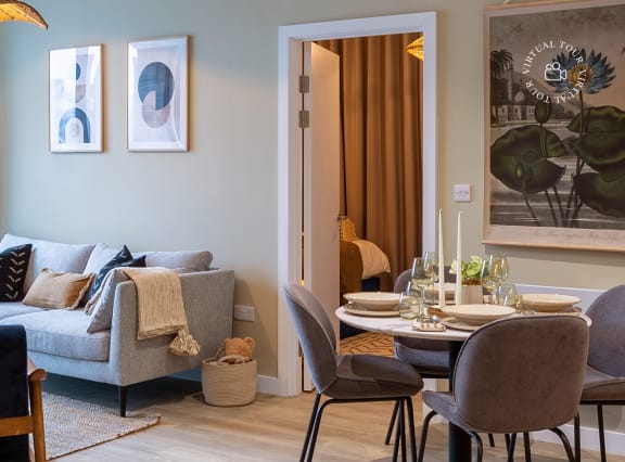 a living room and dining room with a table and chairs