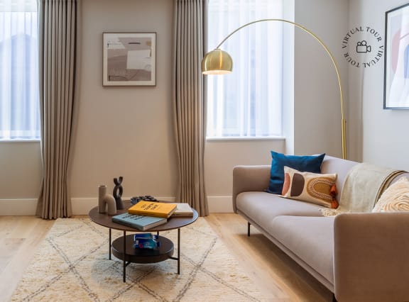 a living room and dining room with a table and chairs