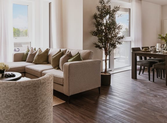 a living room and dining room with a table and chairs