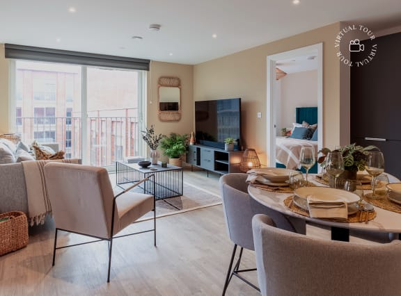 a living room and dining room with a table and chairs