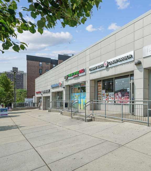 A Subway restaurant is located in a shopping plaza.