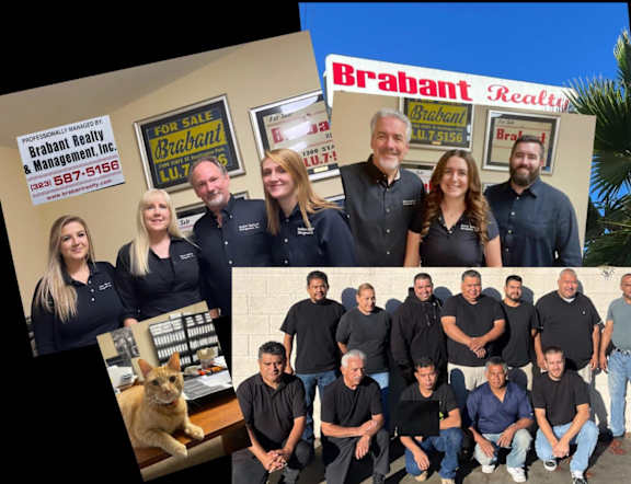 A group of people are posing for a photo in front of a sign that says "Brabant Realty".