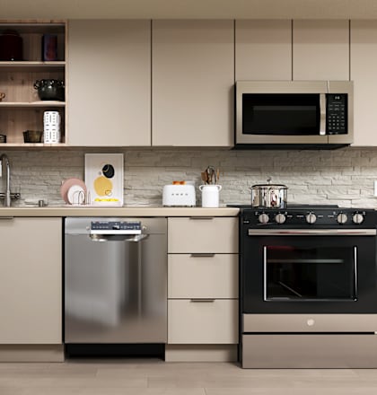 A modern kitchen with a stainless steel dishwasher and oven.