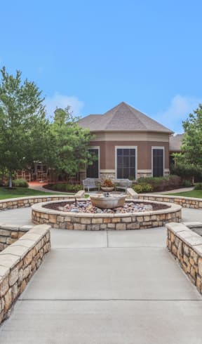 an image of an apartment complex with a fountain in the middle of the walkway  at Stonepost Lakeside Apartments , Kansas , 66103