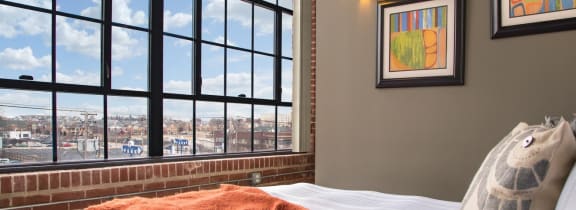 a hotel room with a bed and a view of the city