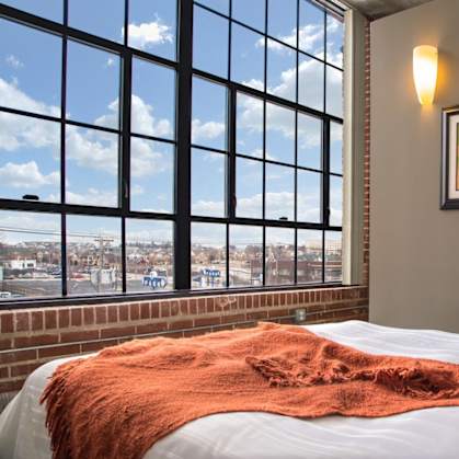 a hotel room with a bed and a view of the city