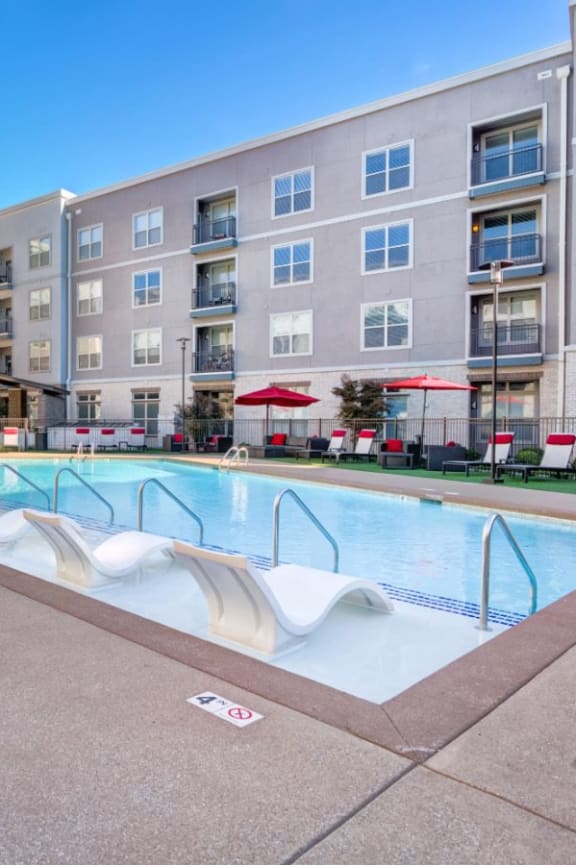 a swimming pool in front of an apartment building