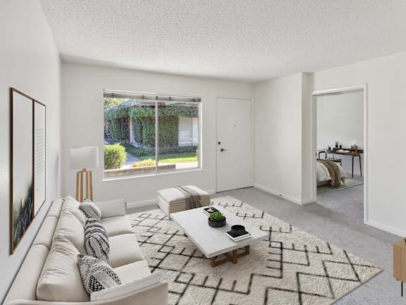 Model Living Room with Carpet and Window View at The Grove at Walnut Creek Apartments located in Walnut Creek, CA-LRGAM.
