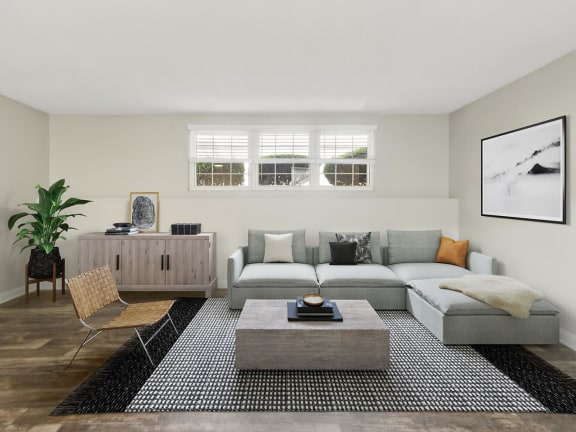 Model Living Room with Wood-Style Flooring at Meadows at Marlborough Apartments located in Marlborough, MA-LRGAM.