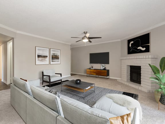 Model Living Room with Carpet and Fireplace at Saratoga Ridge Apartments located in North Phoenix, AZ-LRGAM.