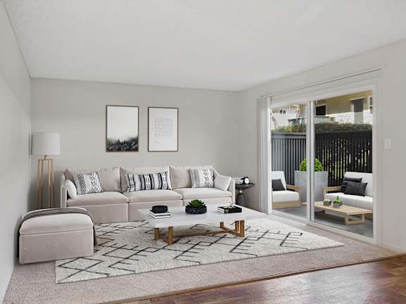 Model Living Room with Carpet and Patio Accessibility at Los Gatos Landing Apartments located in San Jose, CA-LRGAM.