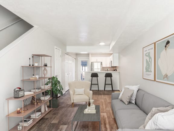 Model Living Room with Wood-Style Flooring at Broadmoor Village Apartments located in West Jordan, UT-LRGAM.